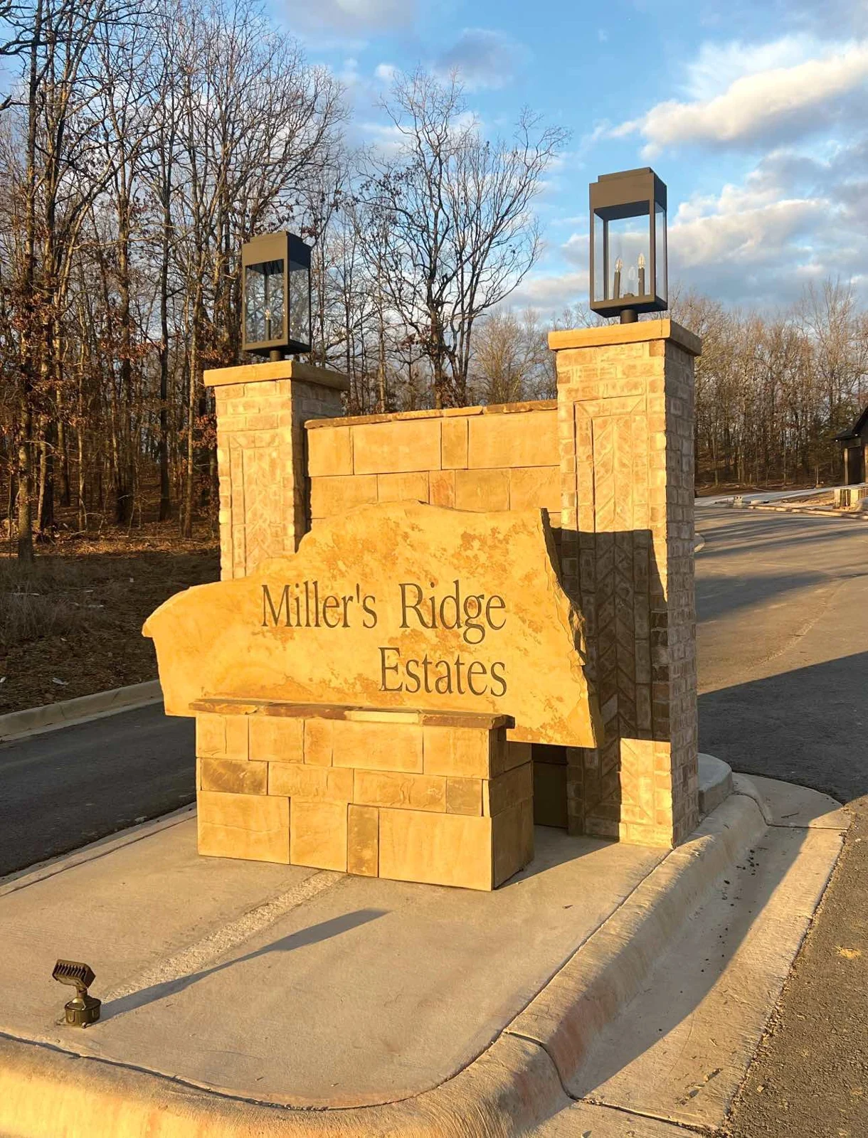 Stone entrance sign and lanterns at Miller’s Ridge Estates